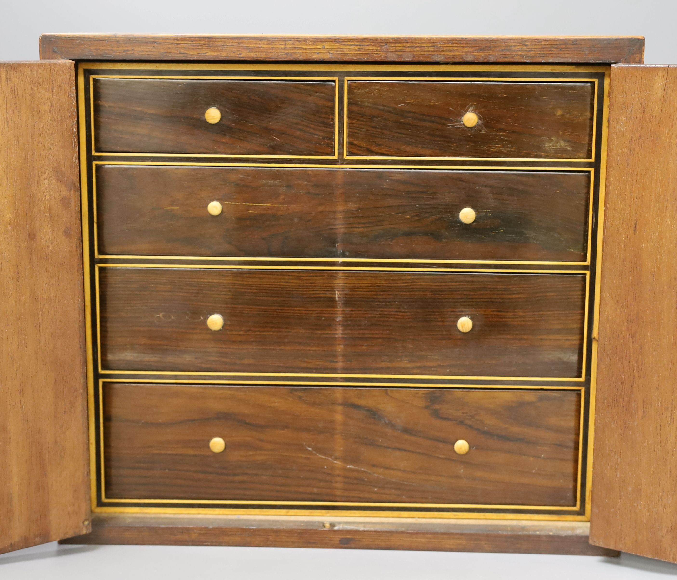 A Regency brass inlaid rosewood table cabinet, fitted with five drawers - 30cm tall